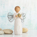 Willow Tree Angel of the Kitchen, 5.5”h hand-painted standing resin figure in cream dress with wire wings, holding green teapot, in front of sky blue painting
