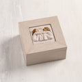 Cream wood box with hinged lid. Inset bas-relief plaque of two seated girls, facing each other.