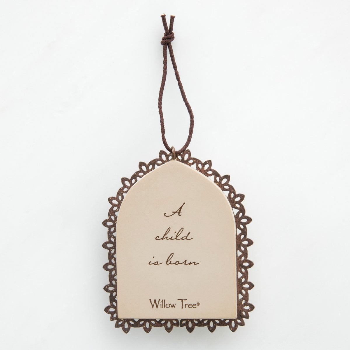 Round cream pendant with wooden outline - center says 'a child is born'