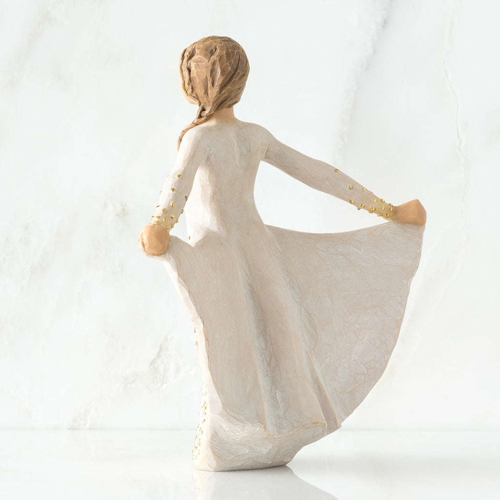 Back view of brunette woman in white dress holding up her dress