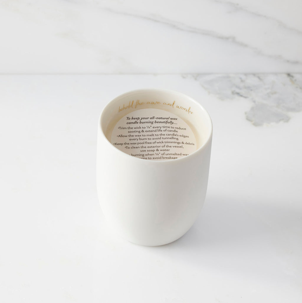 Top view of candle with vellum insert sheet with burning instructions