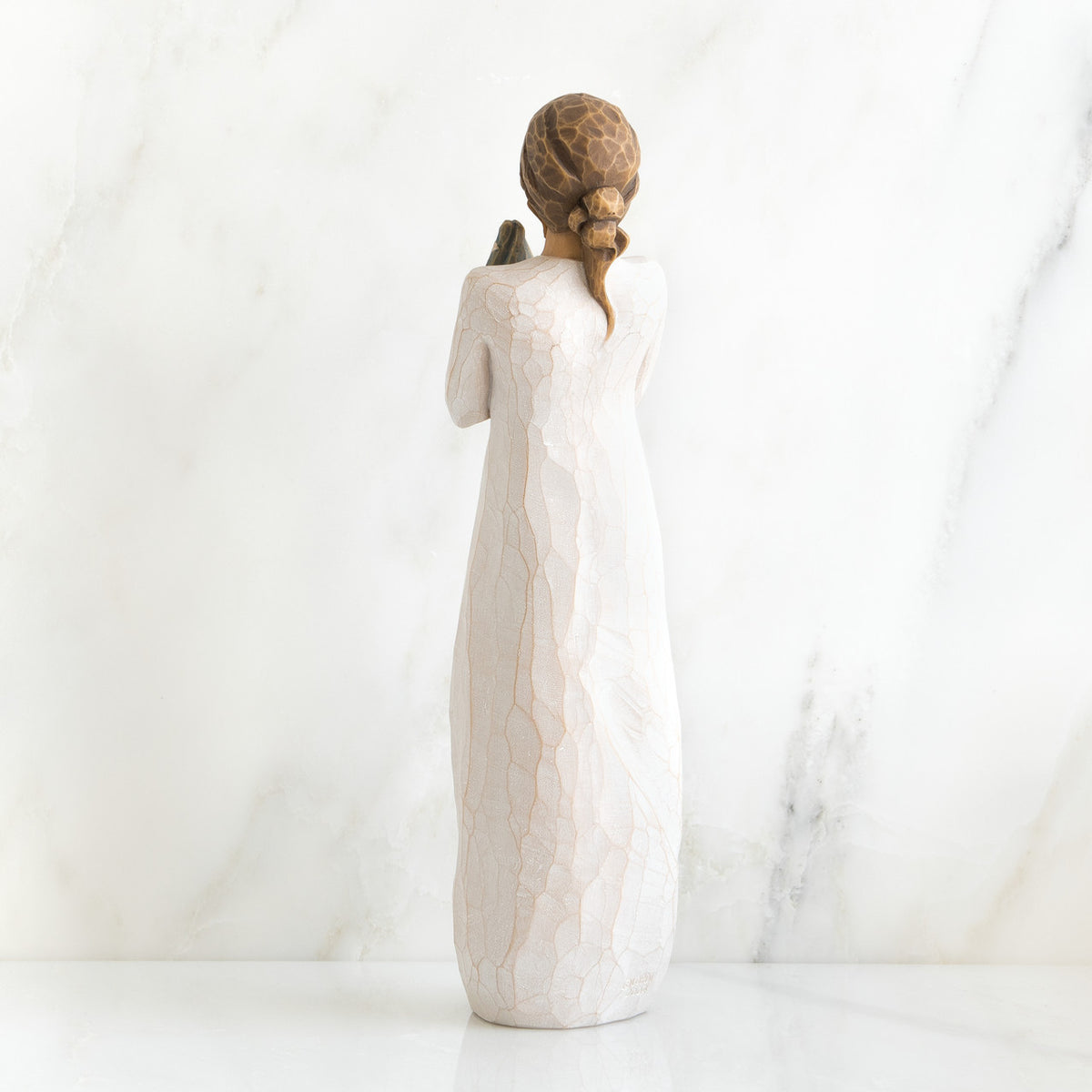 Back view of brunette woman in white dress standing up
